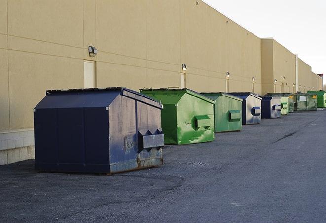 multiple construction dumpsters at a worksite holding various types of debris in Brook Park